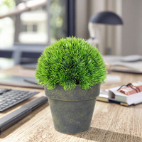 Une belle plante artificielle en pot en forme de boule de pin