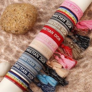 ของขวัญเทศกาลโบฮีเมียน กำไลข้อมือผ้าริบบิ้นปักอักษรตามสั่ง พร้อมพู่ห้อย - Product Image 4