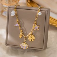 Collier en acier inoxydable plaqué or 18 carats sur le thème de l'océan, pendentif étoile de mer, perle, coquillage, design étoile pour femme - Cadeau, usage quotidien