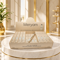 Parfum pour femme en roll-on, flacon givré, boîte dorée, miroir rond, intérieur boisé chaud, tenue longue durée