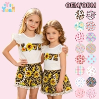 Vêtements pour enfants décontractés en gros, ensemble 2 pièces pour petite fille, haut rose uni à manches volantées et short à bordure pompon, confectionnés sur mesure