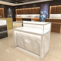 Mostrador de tienda minorista de oro de lujo, mesa de exhibición de diseño, joyería, muebles, escaparates de joyería de cristal, luces Led