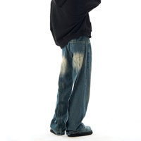 Pantalon décontracté en jean délavé style artisanal, coupe droite ample avec micro-déchirures et motif ondulé, vente en gros