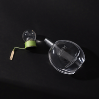 Logo personnalisé de gros 50ml oblate atomiseur vaporisateur de parfum en verre avec bouchon à bille ronde avec processus d'enroulement vert Surlyn
