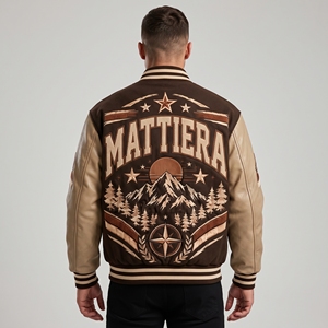 Blouson universitaire marron pour homme avec manches en cuir crème, motif montagne brodé, fermeture à boutons-pression, style streetwear côtelé - Product Image 1