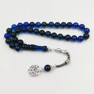 Warm amber-<b>toned</b> smooth round tasbih prayer beads attached to an elegant matching <b>red</b> cord, available at wholesale prices. - Product Image 2