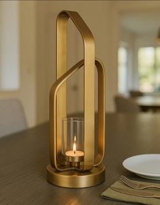 Porte-bougie moderne en métal doré en forme d'arche avec insert cylindrique en verre transparent pour une décoration élégante de table et de la maison - Product Image 1