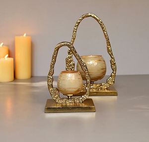 Gglass votive holder has a golden finish on <b>top</b> and a metal gold frame is made of sturdy aluminium - Product Image 1