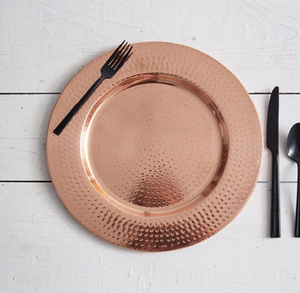 Elegant hammered rose gold charger <b>plate</b> with sleek <b>black</b> cutlery on white wood. Gorgeous presentation available Wholesale price - Product Image 1