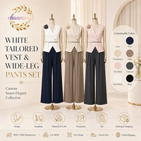 Costume élégant pour femmes, sans manches et cintré à la taille, en noir et blanc, adapté aux occasions formelles.