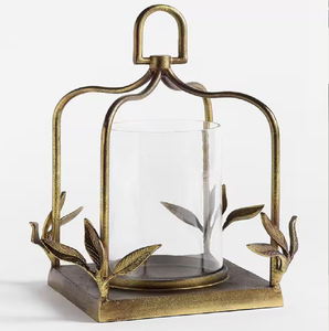 Stunning triptych <b>gold</b> <b>lantern</b> featuring a classic wire frame holding three glowing glass pillars. Available at wholesale price. - Product Image 2