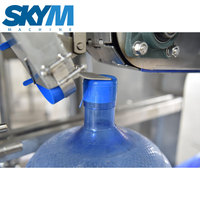 Machine de remplissage d'eau automatique pour fûts en plastique de 5 gallons, contrôlée par PLC, machine 3-en-1 de lavage, remplissage et bouchage