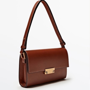Refined tan leather <b>shoulder</b> <b>bag</b> with <b>white</b> stitching and a rectangular gold clasp. Available at wholesale prices. - Product Image 1