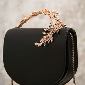 Sleek black saddle bag with a stunning <b>gold</b> leaf handle. Available at wholesale prices. - Product Image 1