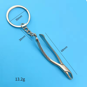Llaveros de acero inoxidable de 68 mm con diseño de equipo dental de MARI INSTRUMENTS, ideales para regalos de doctor o promociones de clínicas. - Product Image 1