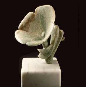 Elegant light green soapstone <b>flower</b> carving mounted on a white rectangular marble base, available at wholesale prices. - Product Image 1