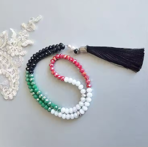 Warm amber-<b>toned</b> smooth round tasbih prayer beads attached to an elegant matching <b>red</b> cord, available at wholesale prices. - Product Image 6