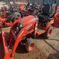 Tractor Kubota BX23S en buen estado con cargador frontal y retroexcavadora, implementos de cortacésped disponibles