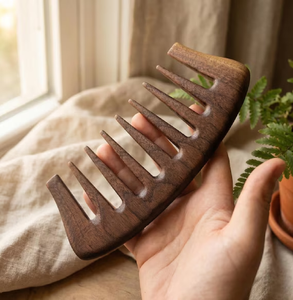 Dark handcrafted wooden <b>comb</b> with <b>widely</b> spaced thick teeth for effortless hair detangling, available at wholesale prices. - Product Image 1