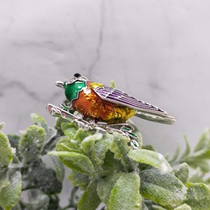 Bird Branch Brooch with Vibrant <b>Hand</b>-Painted Enamel in Emerald and Sunset Tones Elegantly Perched on Silver - Product Image 1