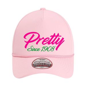 AKA Pretty Since 1908 Flex Fit Hat หมวกเบสบอลทรงแข็งสีชมพู ปักลายกรีก สำหรับผู้หญิง - Product Image 1