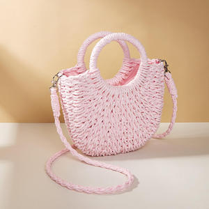 Complementa tus atuendos para el clima soleado con este encantador bolso de hilo natural con una silueta curva marrón y asas, disponible hoy. - Product Image 2