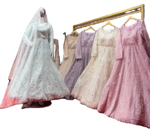 Lehenga élégant avec des morceaux fantaisie et des pierres Jarkan sur un tissu en filet dans des tons clairs avec un aspect lourd - Product Image 1