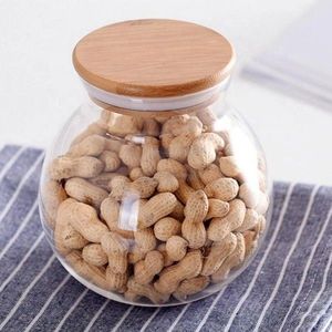 Elegante frasco de vidrio con tapa de madera para decoración y almacenamiento en cocinas modernas, con un aspecto limpio y una cubierta de madera natural. - Product Image 3