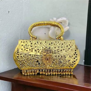 Cartera ovalada de metal de latón dorado antiguo con fina grabatura circular concéntrica y un gran asa redonda. A precios de mayorista. - Product Image 5
