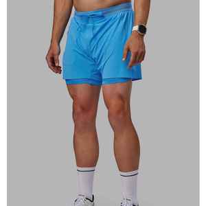 Shorts de sport pour homme en polyester tissé 100 %, bleu uni, séchage rapide, avec cordon de serrage à la taille et design mi-longueur - Product Image 1