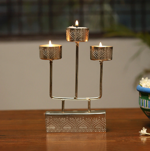 Modern three-tier silver metal candelabra stand with engraved geometric accents. Available at wholesale price. - Product Image 1