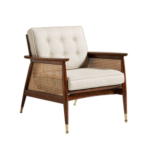 Sturdy single accent <b>chair</b> featuring woven rattan panels, a dark wood frame, and cream-colored tufted <b>cushions</b>. - Product Image 1