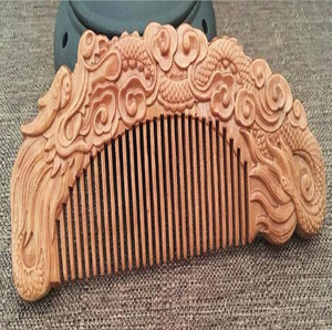 Rustic dark-stained <b>wooden</b> comb <b>carved</b> with complete moon phase cycle motifs along the handle, available at wholesale prices. - Product Image 2