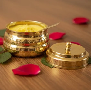 Brilliant hammered brass container filled with fresh ghee, including a knob <b>lid</b>; available at wholesale price. - Product Image 1