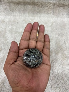 Yooperlite <b>sphere</b> with smoky gray stone body vibrant orange fluorescent glow polished curvature and distinctive mineral display - Product Image 1