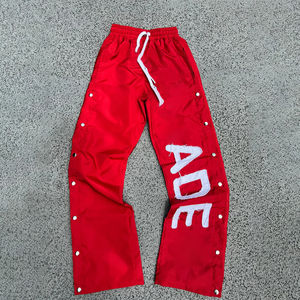 กางเกงแทร็คแพนท์ผ้าไนลอนปักลายโลโก้คุณภาพสูงแบบสั่งทำพิเศษสำหรับผู้ชาย สไตล์สตรีทแวร์ กระดุมแป๊ก ทรงจ็อกเกอร์ ขากว้าง - Product Image 2