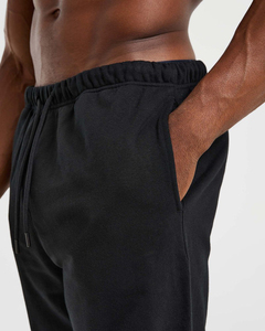 Nouveau pantalon de jogging décontracté pour homme en coton noir, avec logo personnalisé, taille élastique et cordon de serrage, en tissu tricoté, à prix bas - Product Image 5