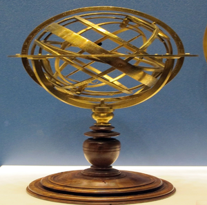 Historical brass armillary sphere model on turned wooden base, available at wholesale prices. - Product Image 1