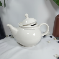 Théière élégante en céramique blanche brillante avec couvercle incliné Mini poterie moderne pour la décoration de la cuisine pour le brassage du thé ou les cadeaux de pendaison de crémaillère