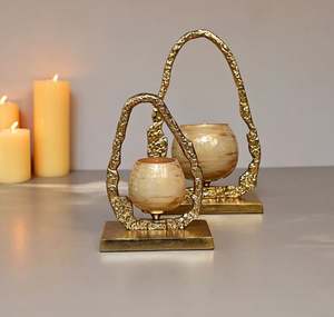 Glass votive holder has a golden finish on <b>top</b> and a metal gold frame is made of sturdy aluminium that wont rust - Product Image 1