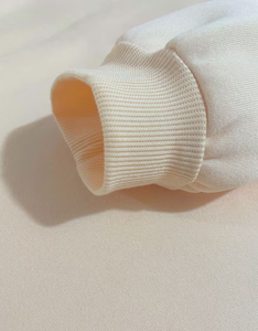 Cream Soft Knit Fabric Textured <b>Cloth</b> <b>Material</b> Close Up View - Product Image 4
