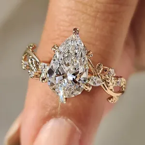 Anillo de Diamantes con Corte Pera en Oro Amarillo Sólido con Detalles Inspirados en Hojas, Piedra de Acento Redonda y Diseño de Compromiso Inspirado en la Naturaleza - Product Image 1