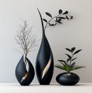 Minimalist matte black abstract silhouette vessels with delicate dried foliage, available at wholesale prices. - Product Image 1