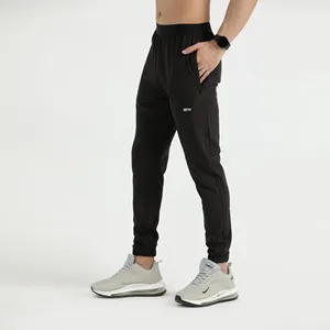 Pantalon de survêtement à logo en caoutchouc uni pour hommes pantalon skinny extensible jogging élastique avec cordon de serrage pantalon de travail léger pour la randonnée et la pêche