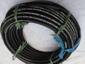 Construction site with <b>coiled</b> black industrial <b>cable</b> on concrete slab heavy machinery building materials - Product Image 2