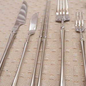 Luxury <b>silver</b> stainless steel flatware set featuring embossed <b>ornate</b> scroll handles and <b>mirror</b> polished heads displayed - Product Image 2