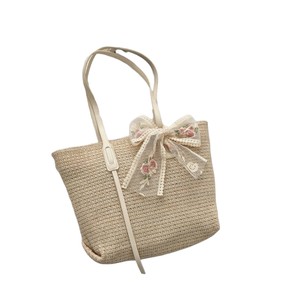 Capture the spirit of modern city life with this stylish Natural yarn bag featuring a structured <b>body</b> and an embroidered <b>bow</b> - Product Image 1