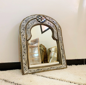 This lovely, <b>small</b> arched wall <b>mirror</b> features a delicate white-and-black floral bone inlay motif available at wholesale prices. - Product Image 1
