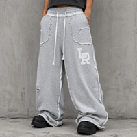 Pantalon de survêtement ample perlé gris chiné en coton à jambe large avec cordon de serrage, bords bruts et poches plaquées, style streetwear OEM ODM