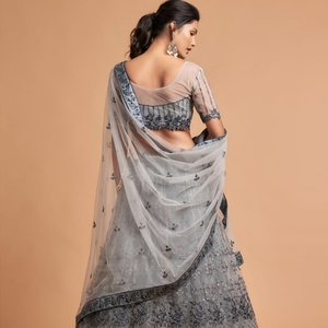 El lehenga semicompuesto en forma de A está hecho de tela de red suave de primera calidad y adornado con intrincados detalles de hilo zari badla dori. - Product Image 2